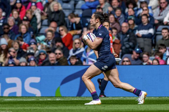 Rugby player carrying the ball during the Women's Six Nations match between Scotland and England in Edinburgh.